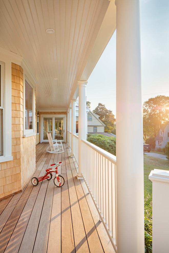 Inspiration for a large nautical front veranda in Boston with a roof extension.