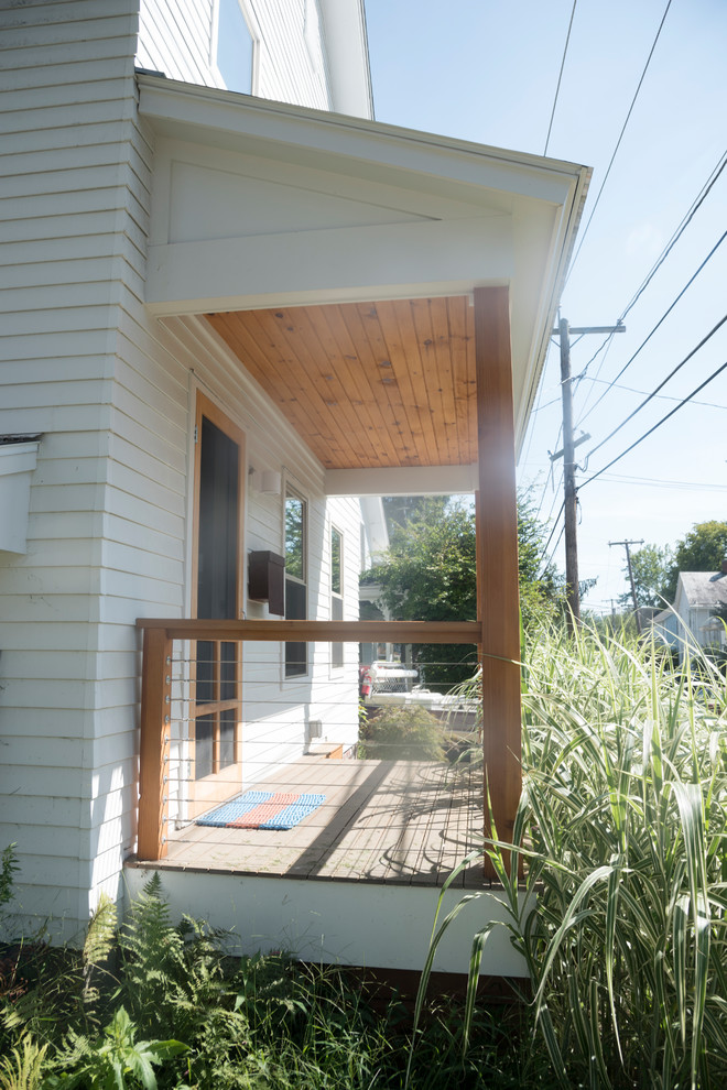 Danish front porch photo in Boston with a roof extension