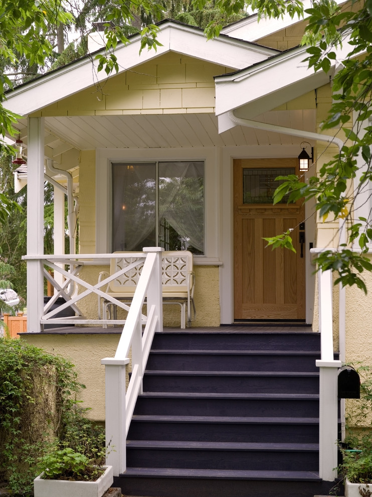 Réalisation d'un porche d'entrée de maison avant tradition de taille moyenne avec une terrasse en bois et une extension de toiture.