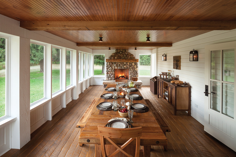 Country screened-in porch idea in Other with decking
