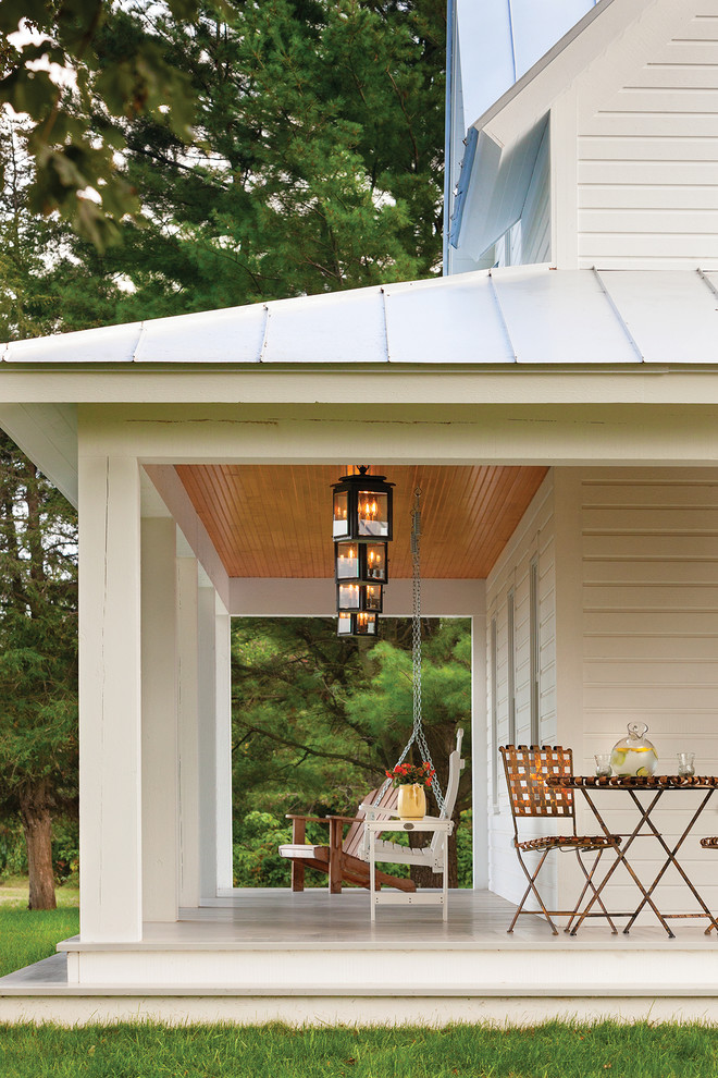 Farmhouse porch idea in Other with a roof extension