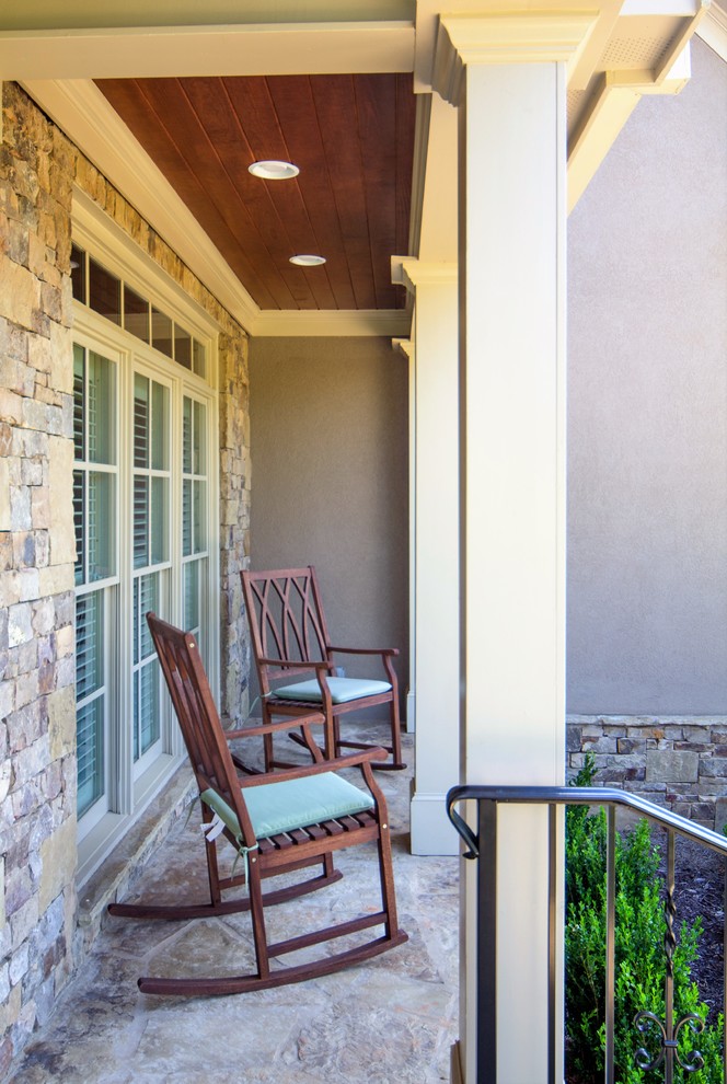 Inspiration for a small traditional front veranda in Atlanta with natural stone paving and a roof extension.