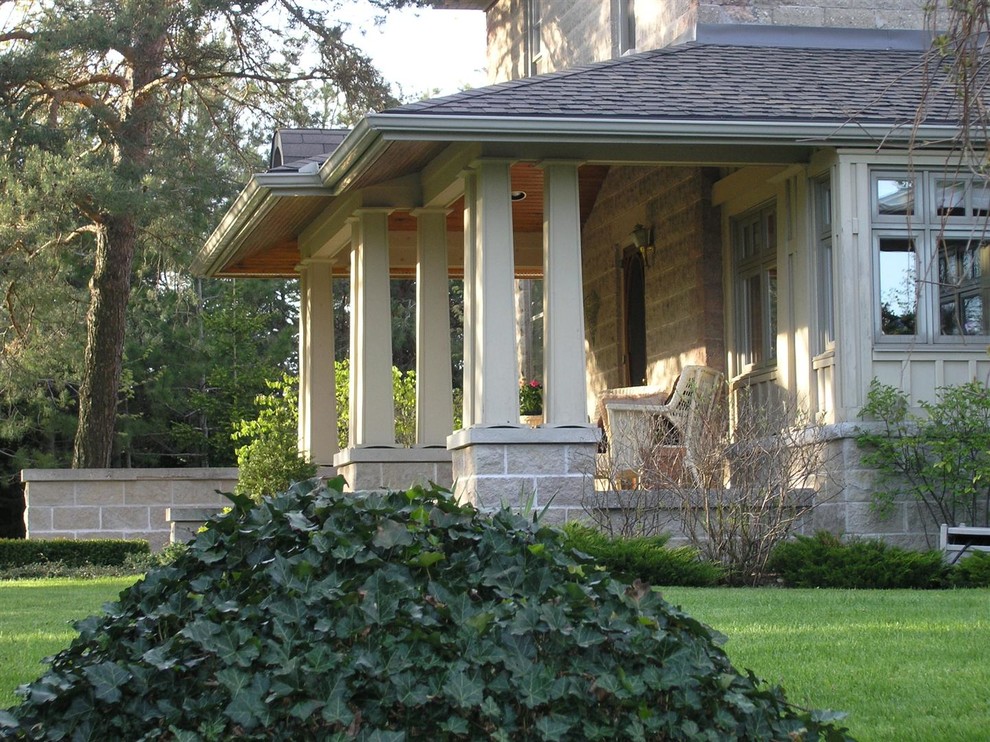 Design ideas for a large traditional front veranda in Toronto with concrete slabs.