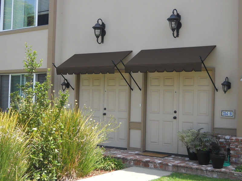 Design ideas for a small mediterranean front veranda in Orange County with an awning.