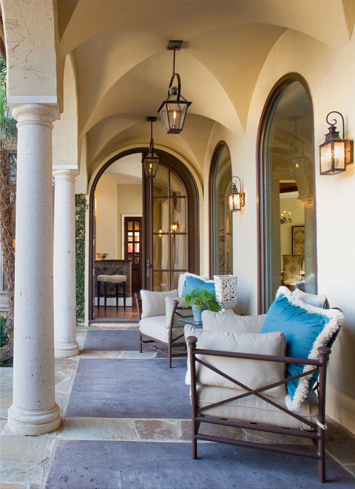 Стильный дизайн: веранда среднего размера на заднем дворе в средиземноморском стиле с покрытием из каменной брусчатки и навесом - последний тренд