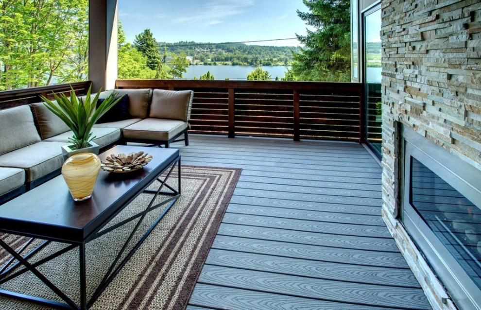 Design ideas for a large contemporary front veranda in Seattle with a fire feature, decking and a roof extension.
