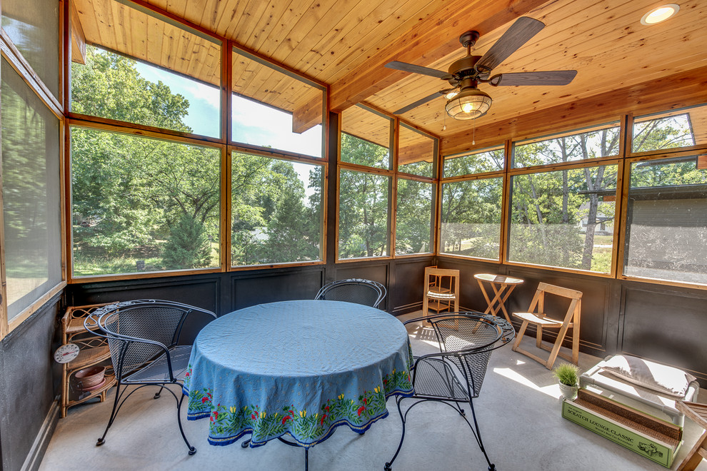 Medium sized retro side screened veranda in Kansas City with concrete slabs and a roof extension.