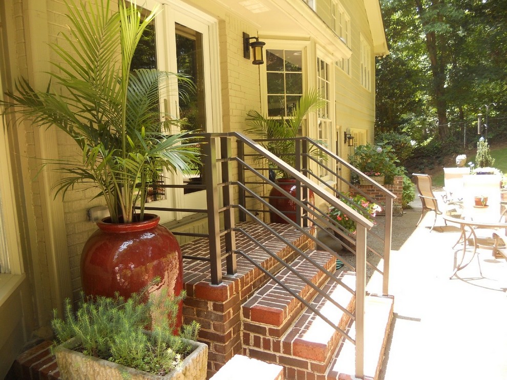 Small traditional back veranda in Atlanta with a potted garden, brick paving and a roof extension.