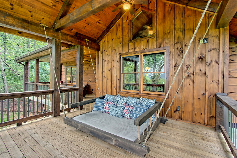 Inspiration for a rustic veranda in Atlanta with a roof extension.
