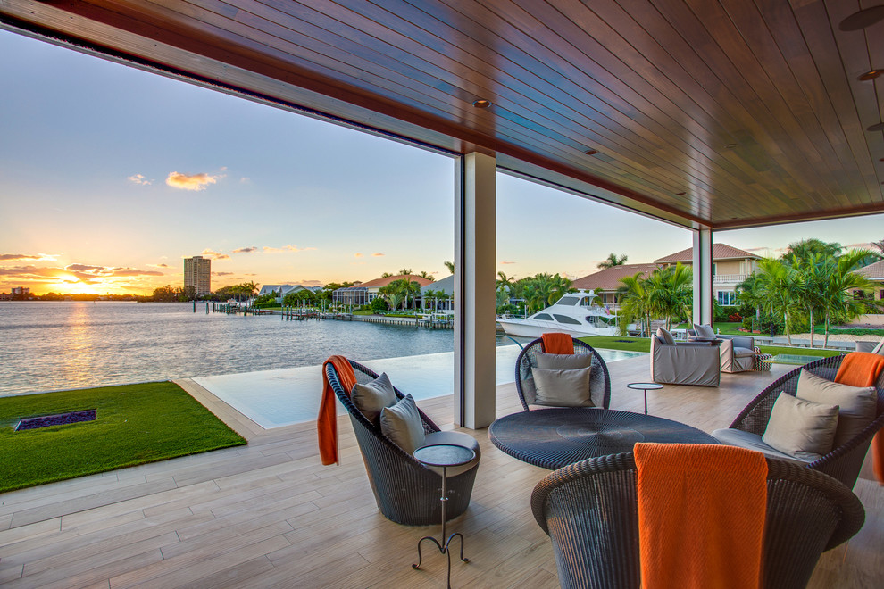 This is an example of a world-inspired back veranda in Tampa with decking and a roof extension.