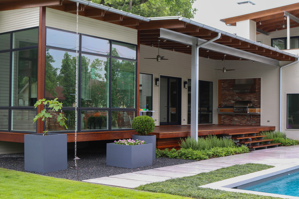 Inspiration for a large modern concrete porch remodel in Houston with a roof extension