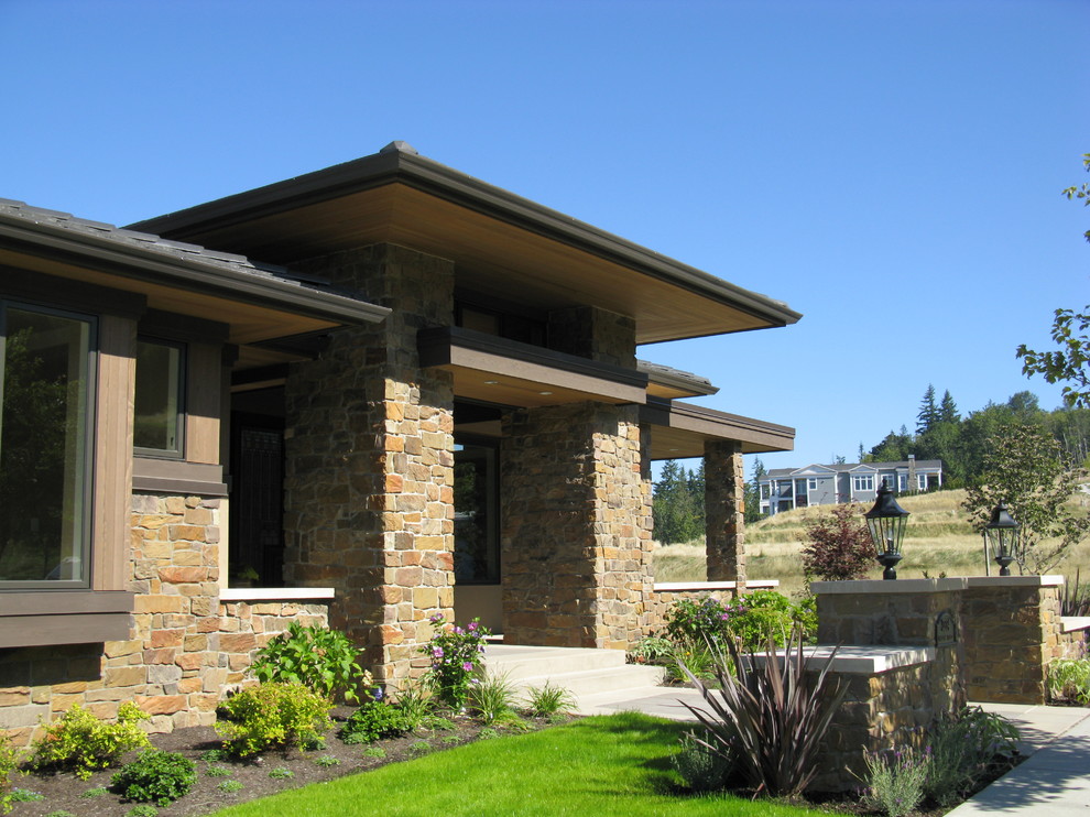 Large elegant concrete paver porch photo in Seattle with a roof extension