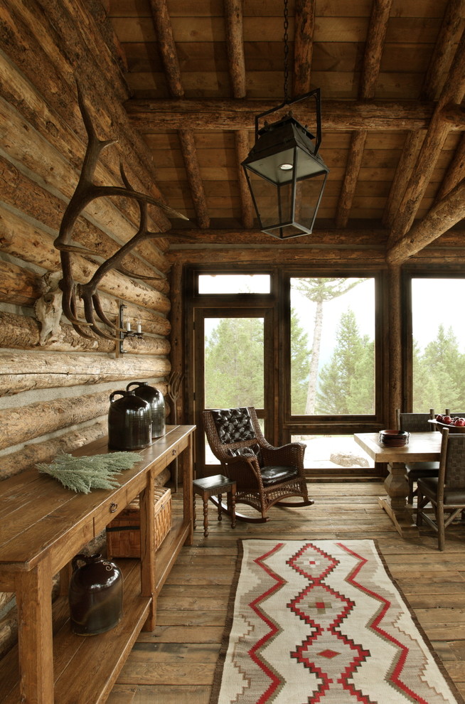 Inspiration for a large rustic front porch remodel in Other with a roof extension