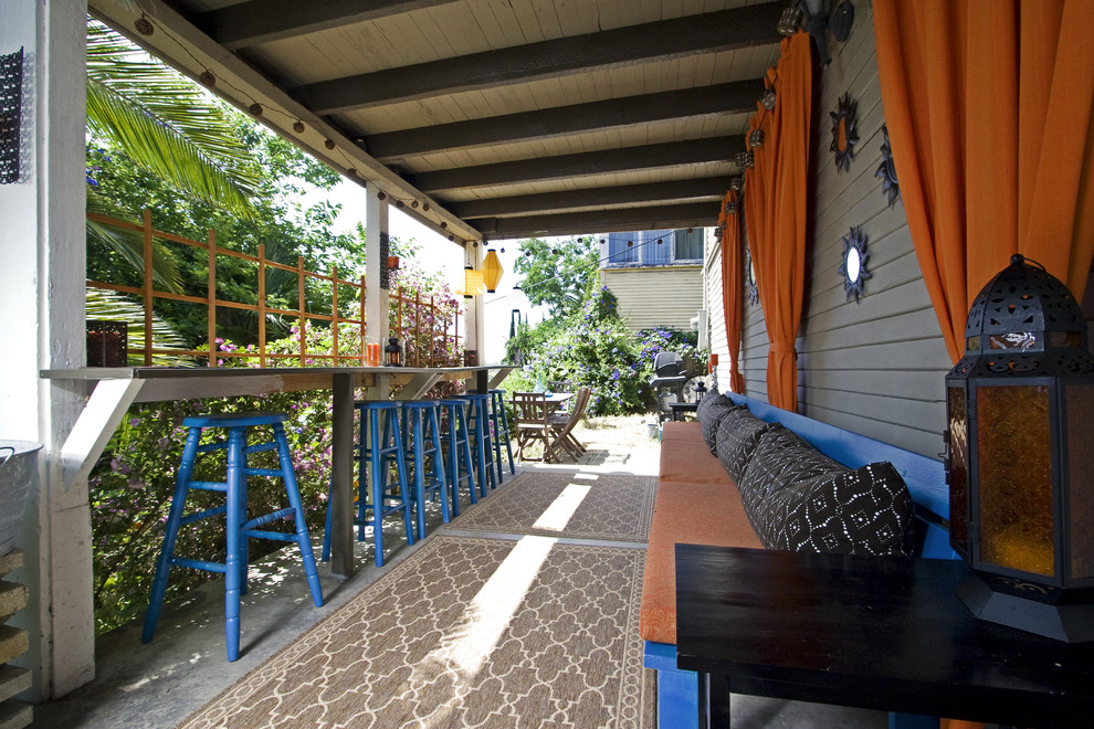 Photo of a mediterranean veranda in San Diego with a roof extension and a bar area.