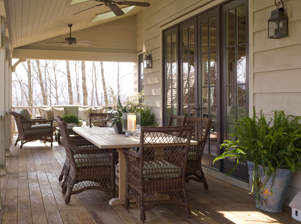 Inspiration for a large timeless side porch remodel in Raleigh with a roof extension
