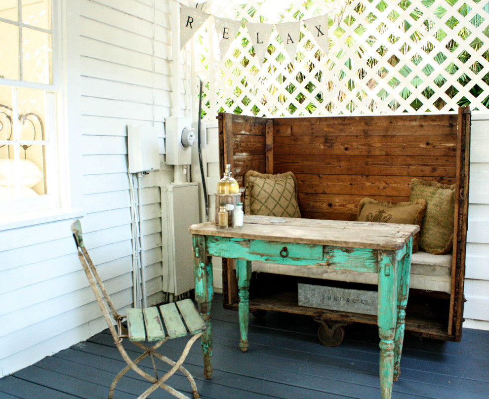 Aménagement d'un porche d'entrée de maison romantique avec une terrasse en bois.