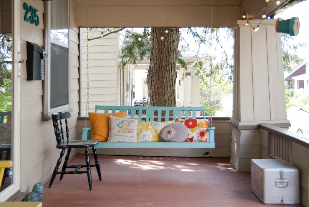 Inspiration for a vintage front veranda in Columbus with a roof extension.
