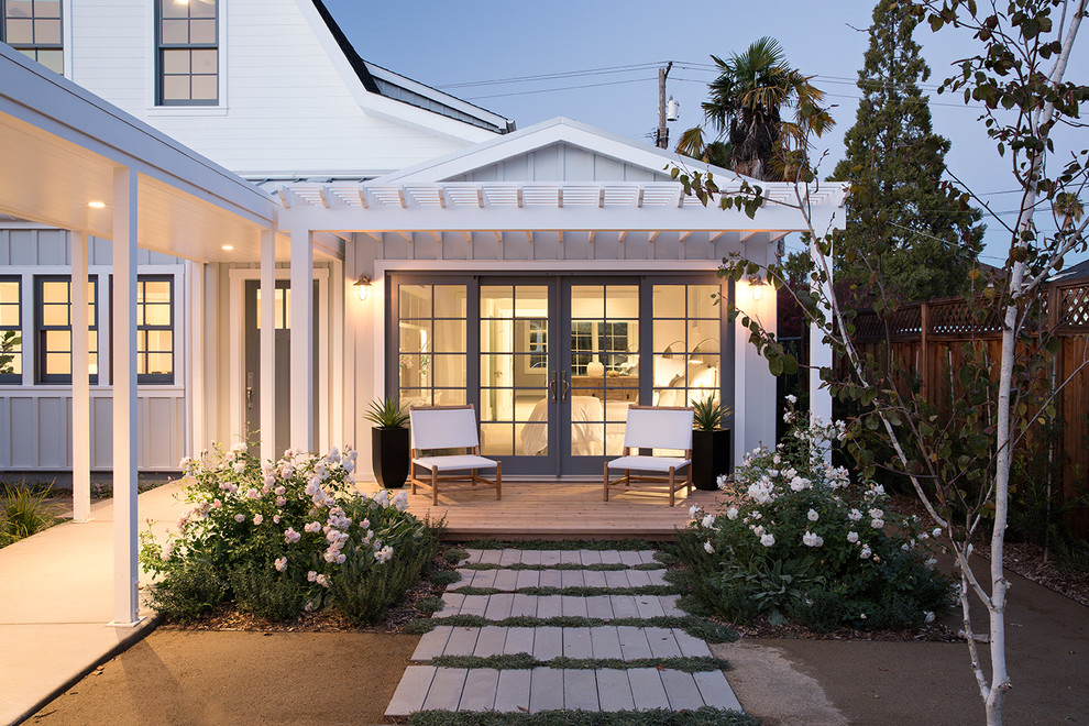 Photo of a rural veranda in San Francisco with a pergola and feature lighting.