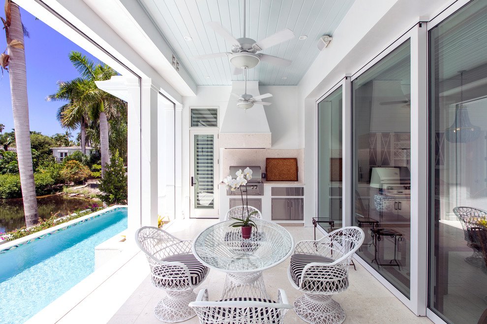Photo of a coastal veranda in Miami with a roof extension and a bbq area.