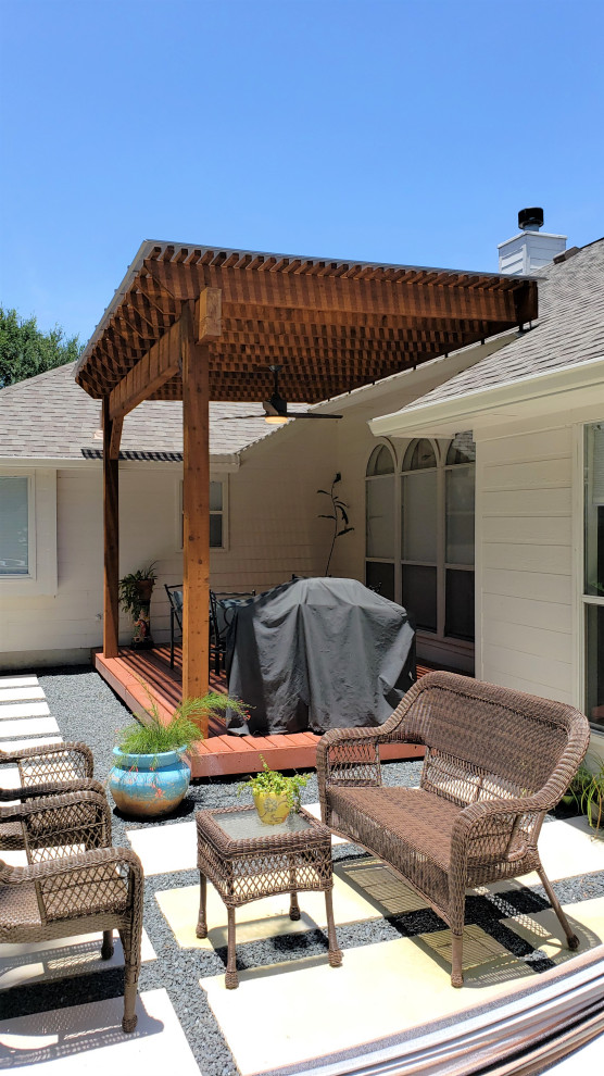 This is an example of a rustic back porch design in Austin with a pergola.