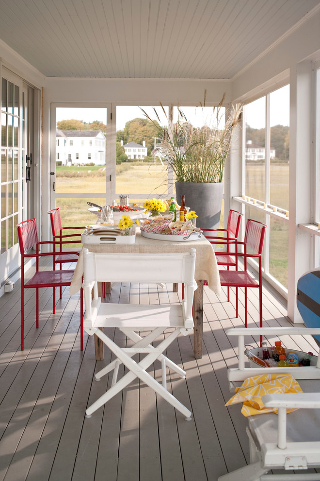 Elegant screened-in porch photo in New York with decking and a roof extension