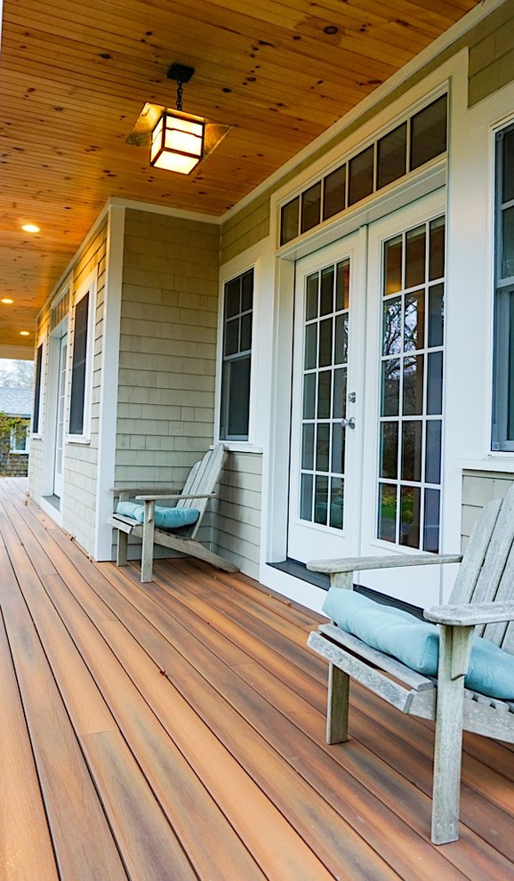 Inspiration for a mid-sized craftsman back porch remodel in Boston with decking and a roof extension