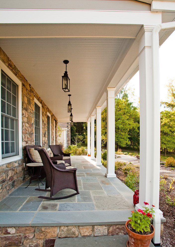 This is an example of a farmhouse veranda in Philadelphia with feature lighting.