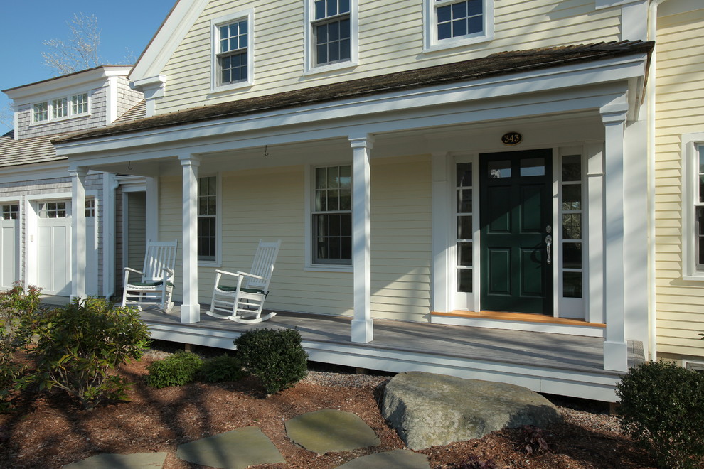 Elegant front porch photo in Boston with a roof extension