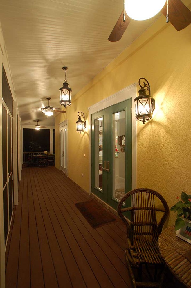This is an example of a large nautical front screened veranda in Tampa with decking and an awning.