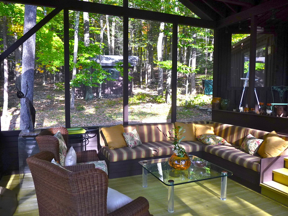 Inspiration for a mid-sized timeless screened-in side porch remodel in New York with decking and a roof extension