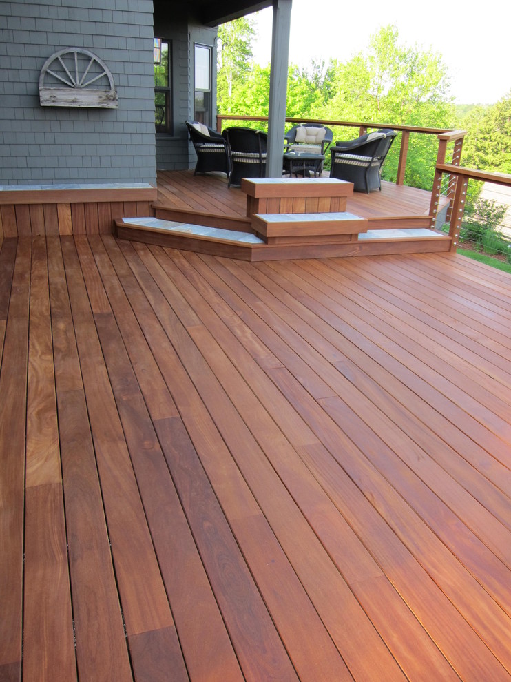 Large elegant backyard deck photo in Boston with a roof extension