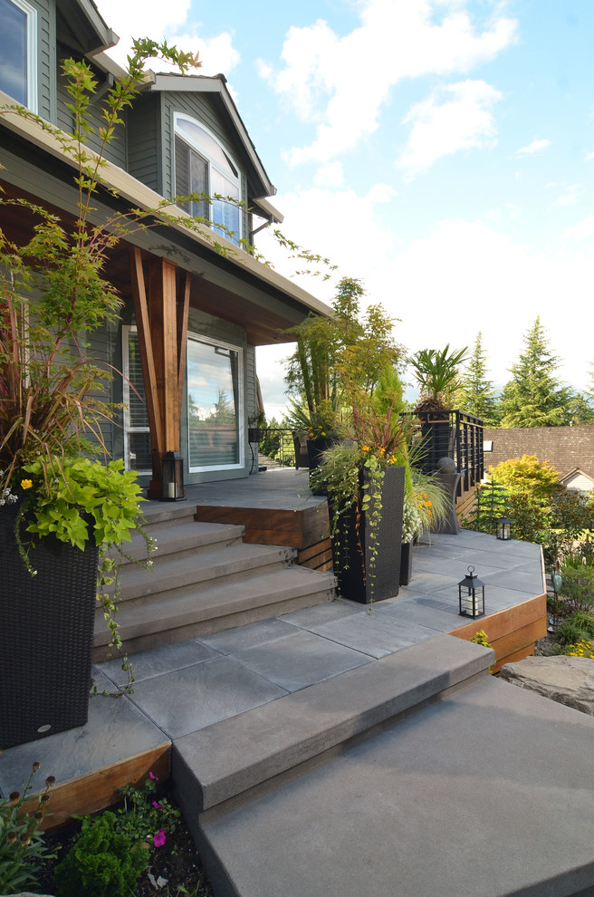 This is an example of a contemporary concrete paver side porch design in Portland.