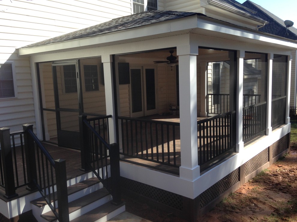 Medium sized traditional back screened veranda in Charlotte with a roof extension.