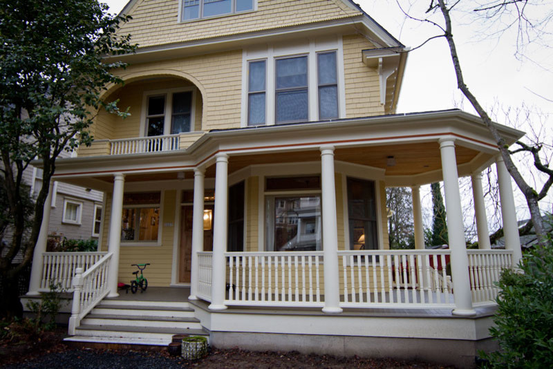 Huge ornate front porch photo in Portland with decking and a roof extension
