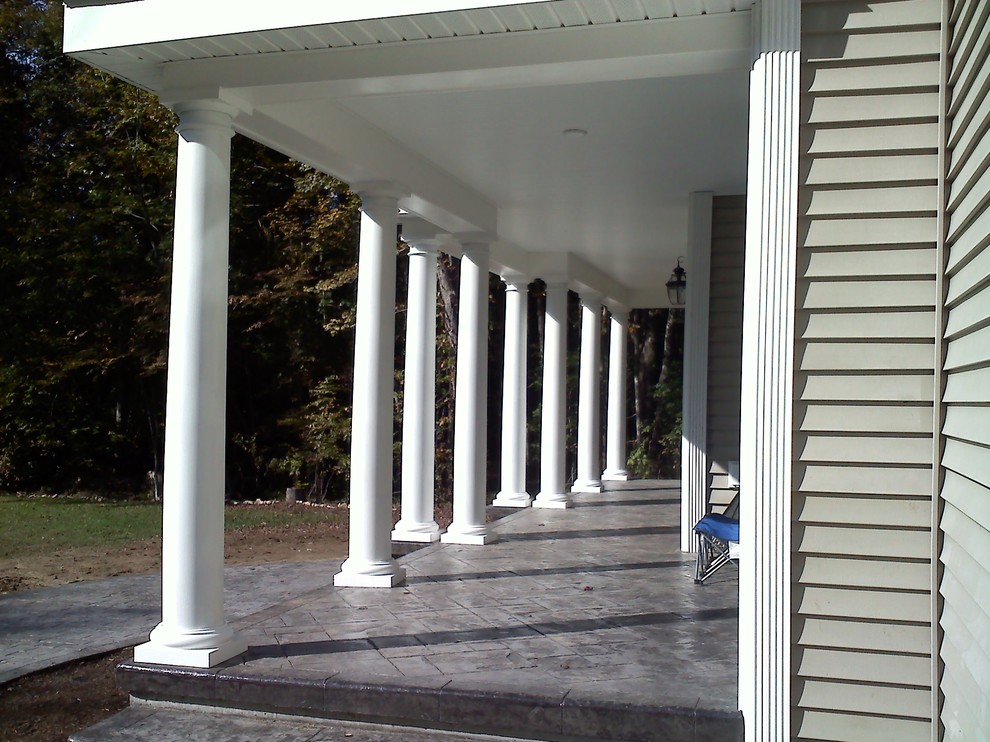 Photo of a classic front veranda in Bridgeport with stamped concrete and a roof extension.