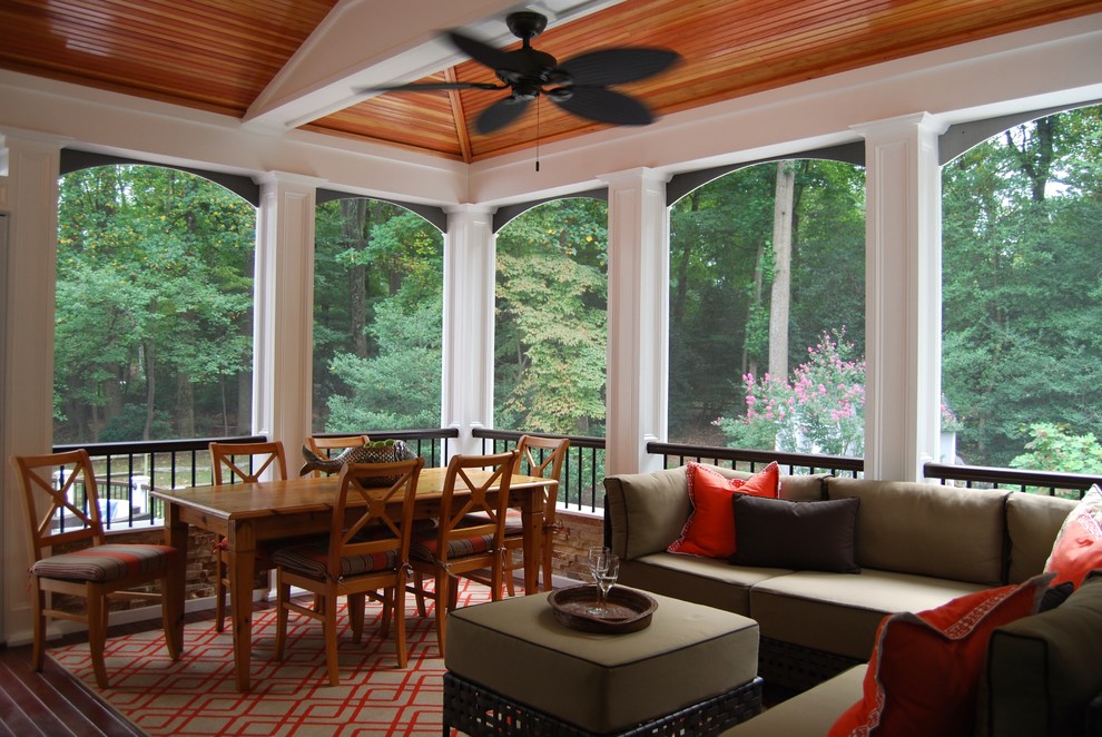 Large elegant screened-in back porch photo in DC Metro with decking and a roof extension