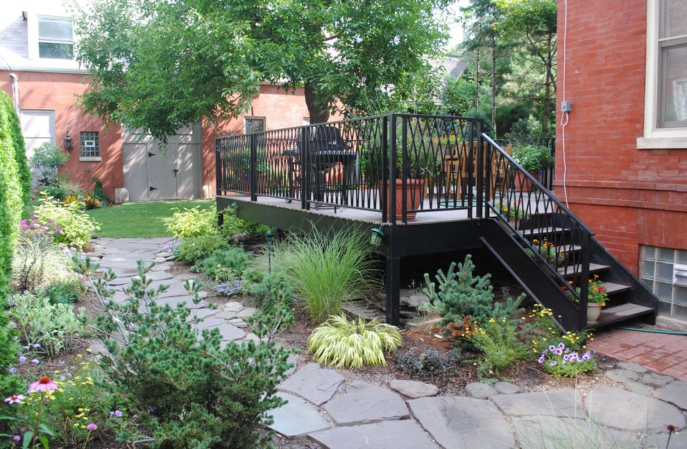 This is an example of a mid-sized traditional back porch design in Chicago with decking.