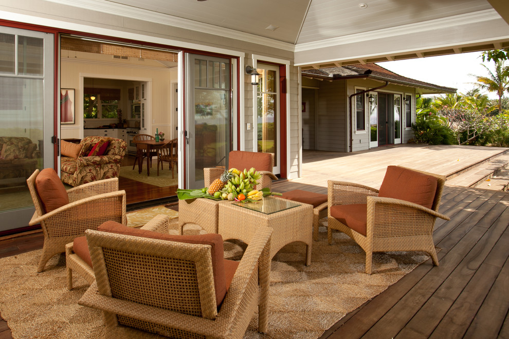 Inspiration for a large tropical back porch remodel in Hawaii with decking and a roof extension