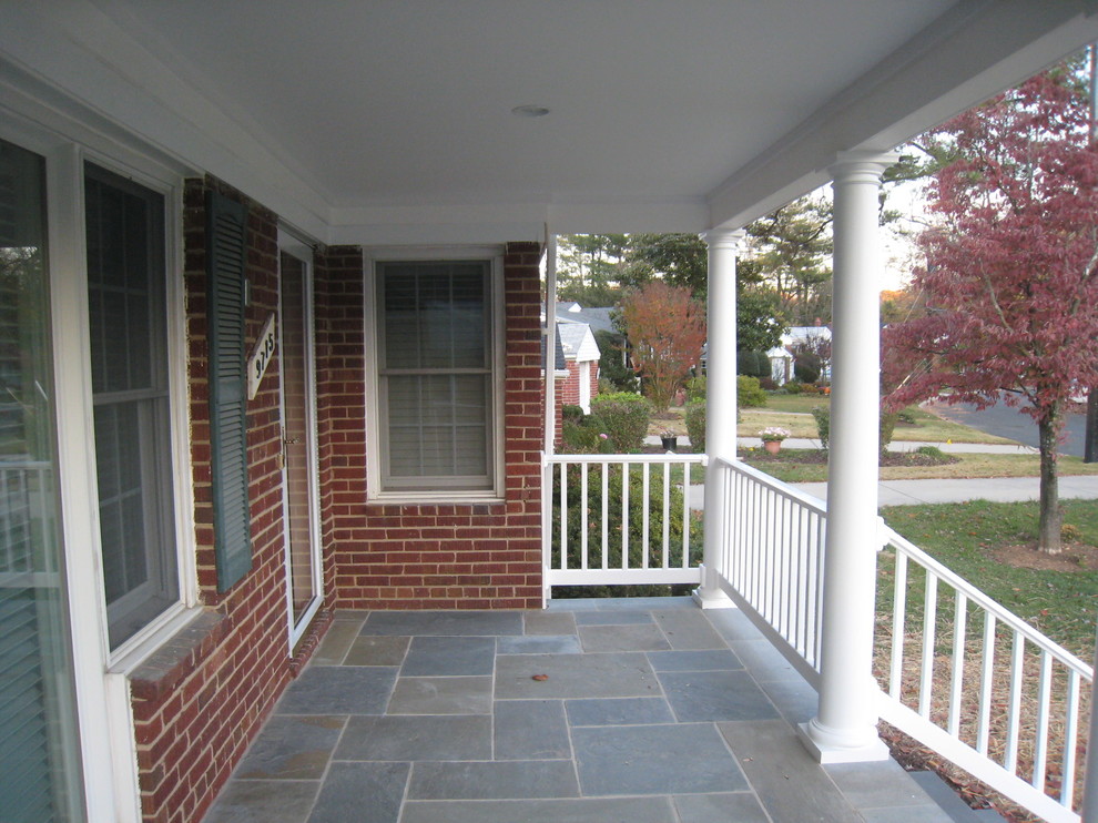 Idée de décoration pour un porche d'entrée de maison avant tradition de taille moyenne avec des pavés en pierre naturelle et une extension de toiture.