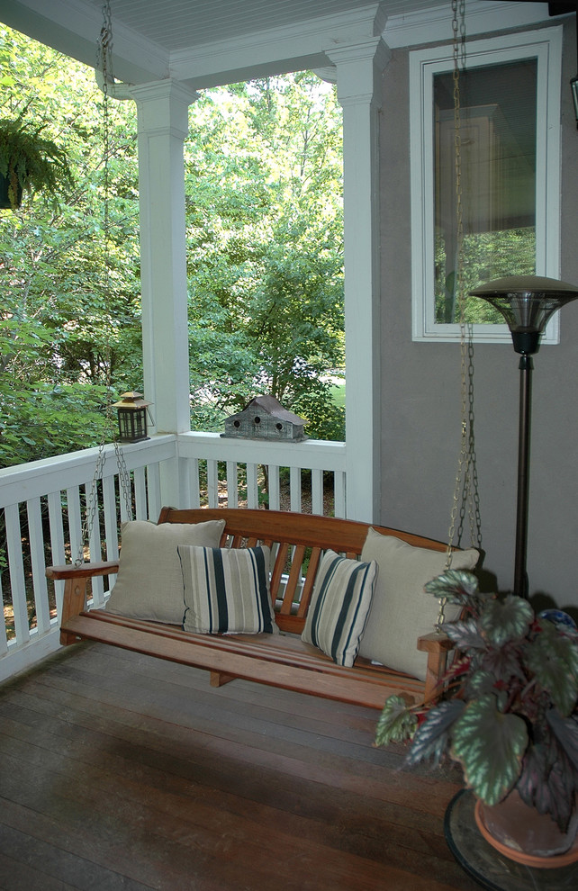This is an example of a medium sized traditional back veranda in Atlanta with a roof extension.