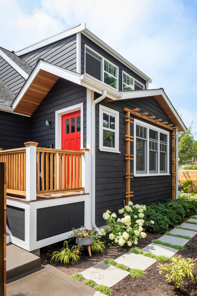 This is an example of a small contemporary front porch design in Seattle with decking and a roof extension.