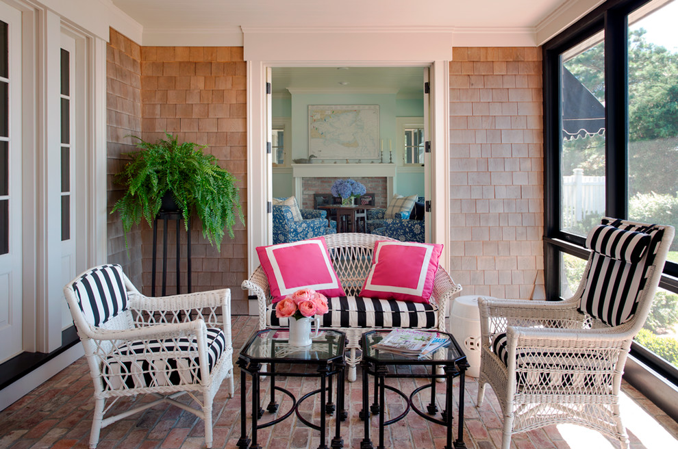 Inspiration for a large coastal brick screened-in back porch remodel in Boston