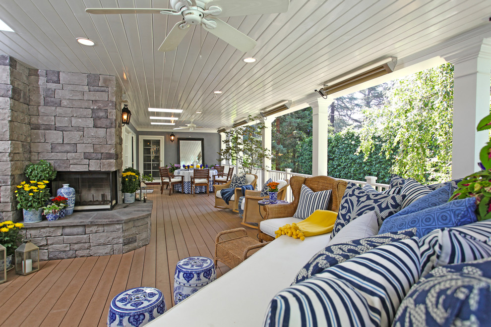 Large elegant back porch photo in Los Angeles with a fire pit, decking and a roof extension
