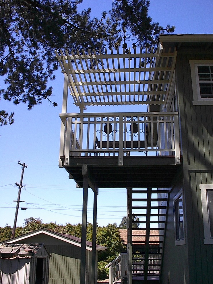 Inspiration pour un petit porche d'entrée de maison arrière traditionnel avec une terrasse en bois et une pergola.