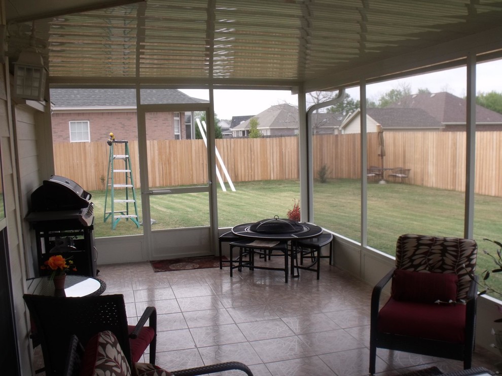 This is an example of a medium sized classic back screened veranda in Other with tiled flooring.