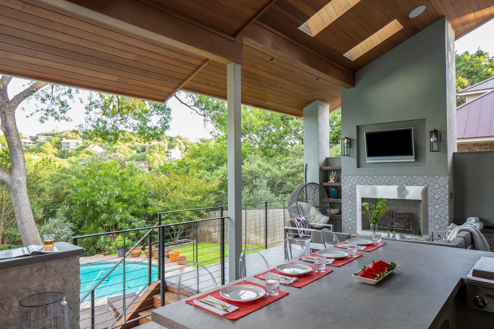 Medium sized contemporary back veranda in Austin with a roof extension and a bar area.