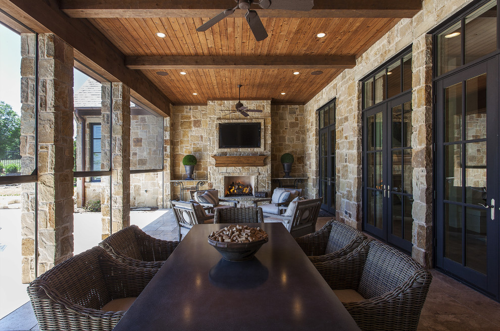 Mountain style porch idea in Dallas with a roof extension and a fire pit