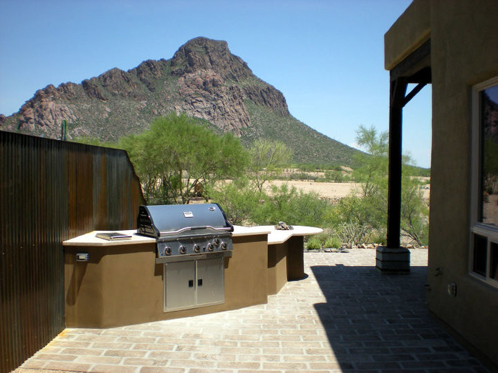 Inspiration for a mid-sized rustic concrete paver porch remodel in Phoenix with a roof extension