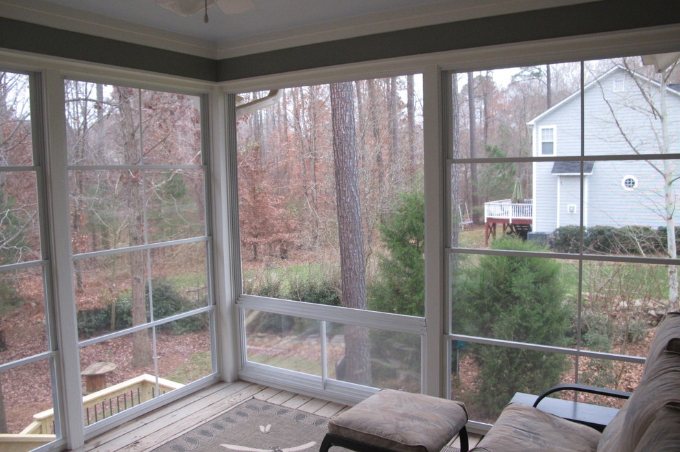 Small elegant screened-in back porch photo in Raleigh with decking and a roof extension