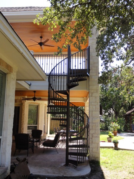 Inspiration for a timeless concrete back porch remodel in Austin with a roof extension